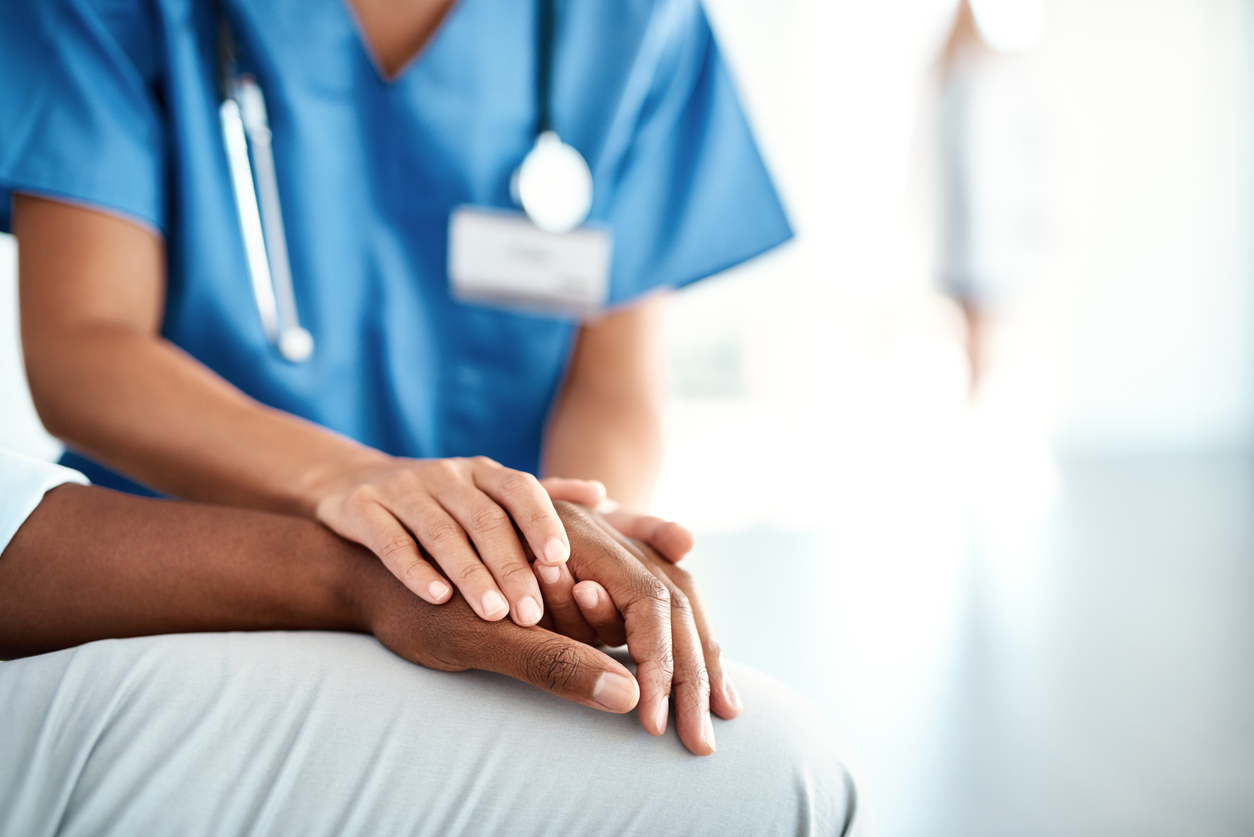 nurse holding hand of patient in the hospital