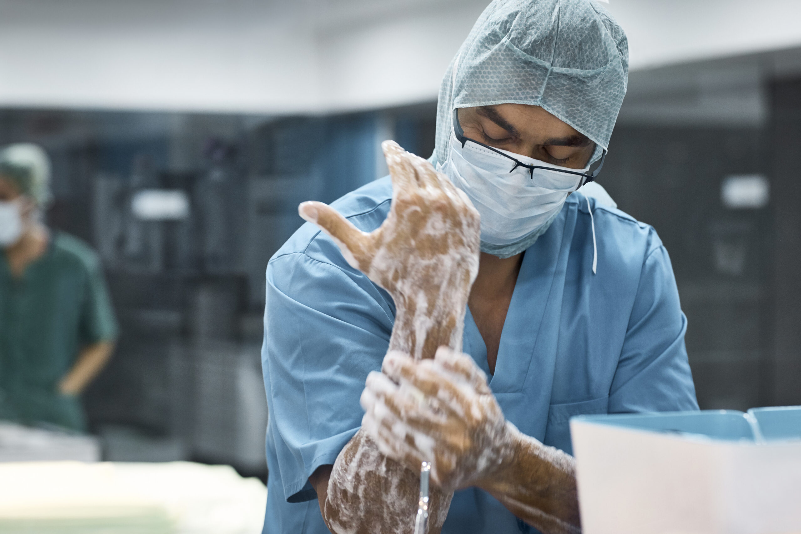 Surgeon washing hands prior to surgery.