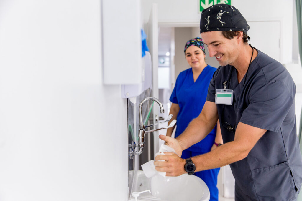 Doctor washing hands using a Hospital tap faucet